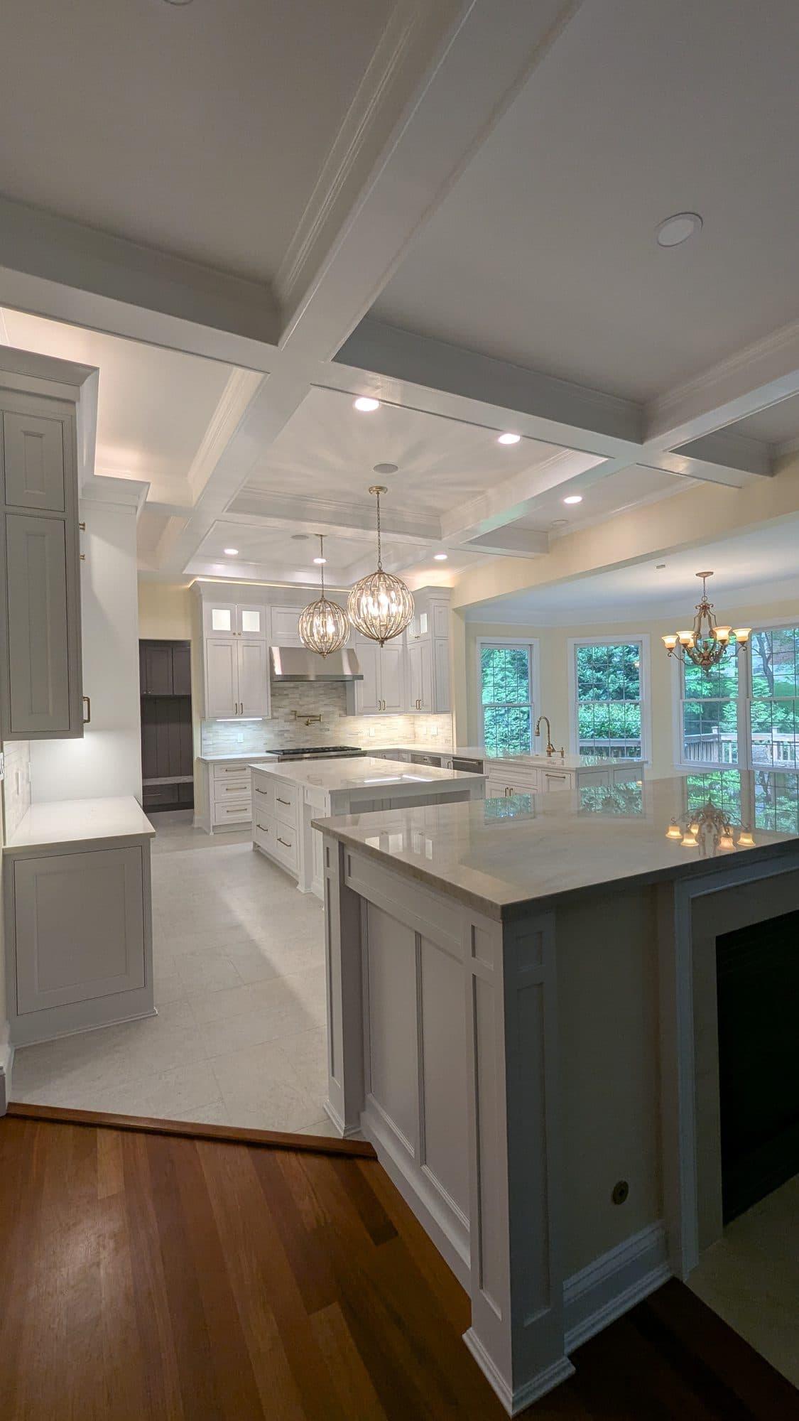 Kitchen island close-up with brass cabinet pulls and marble countertop